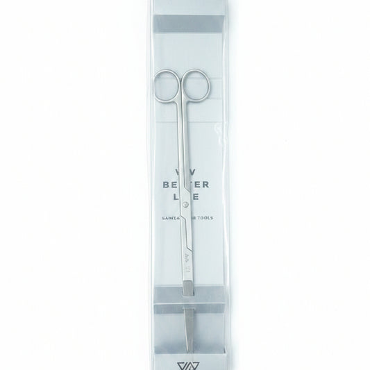 Set of tweezers in a clear plastic case on a wooden surface